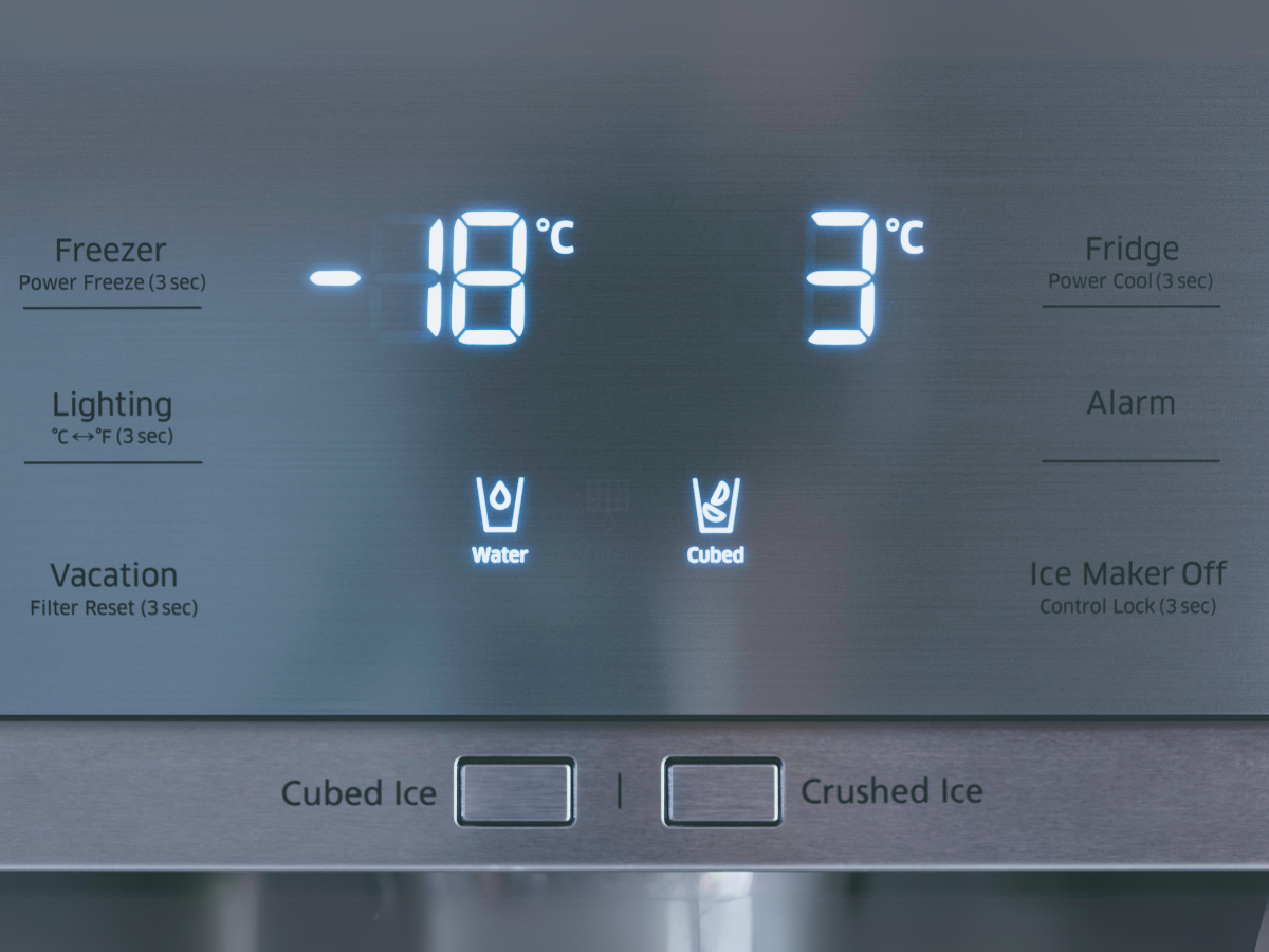 Digital thermometer display showing the current temperature inside a commercial fridge