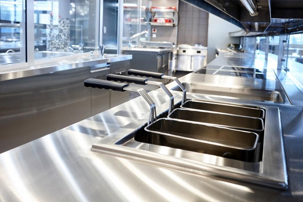 Deep Fryers one of the commercial kitchen equipment in a clean commercial kitchen